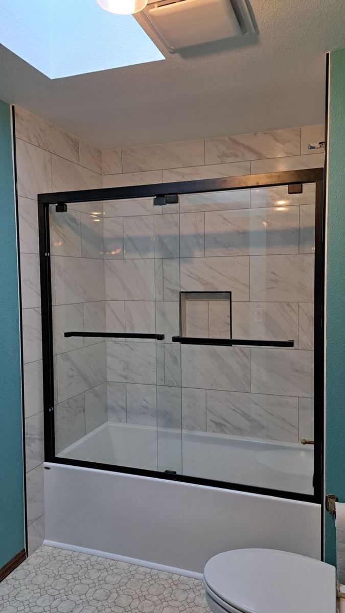 Glass shower under a skylight
