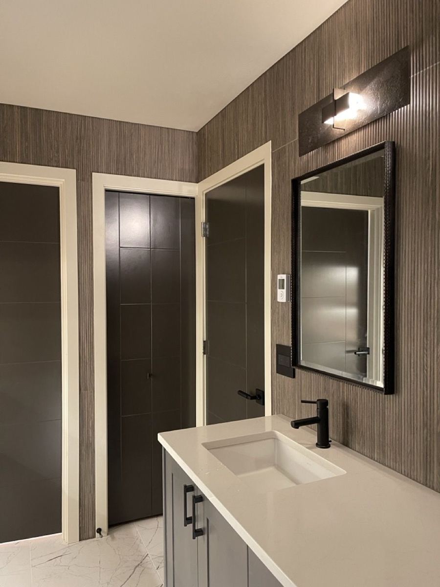 Vanity with dark wood-look wall tile